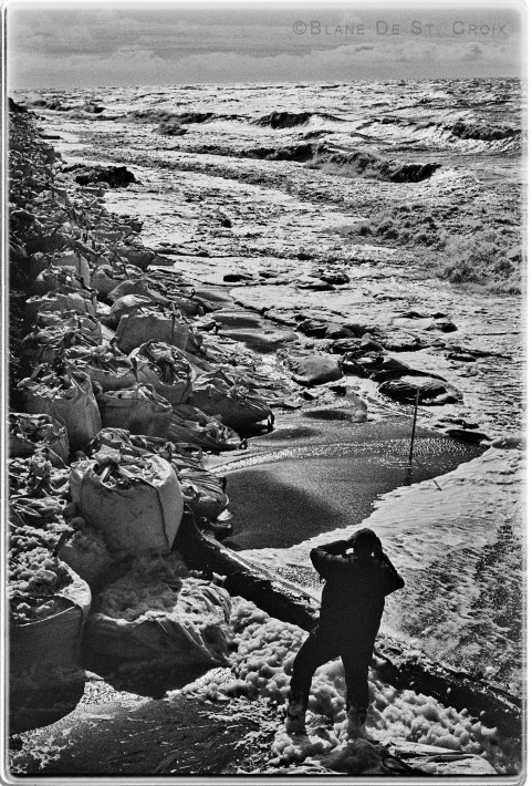 Artist looks out over super bags (gravel bags to protect coastal surges and storms) Arctic Ocean, High Arctic Utqiagvit, AK
